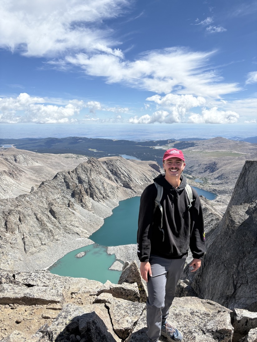 Drew Marchant hiking in the mountains