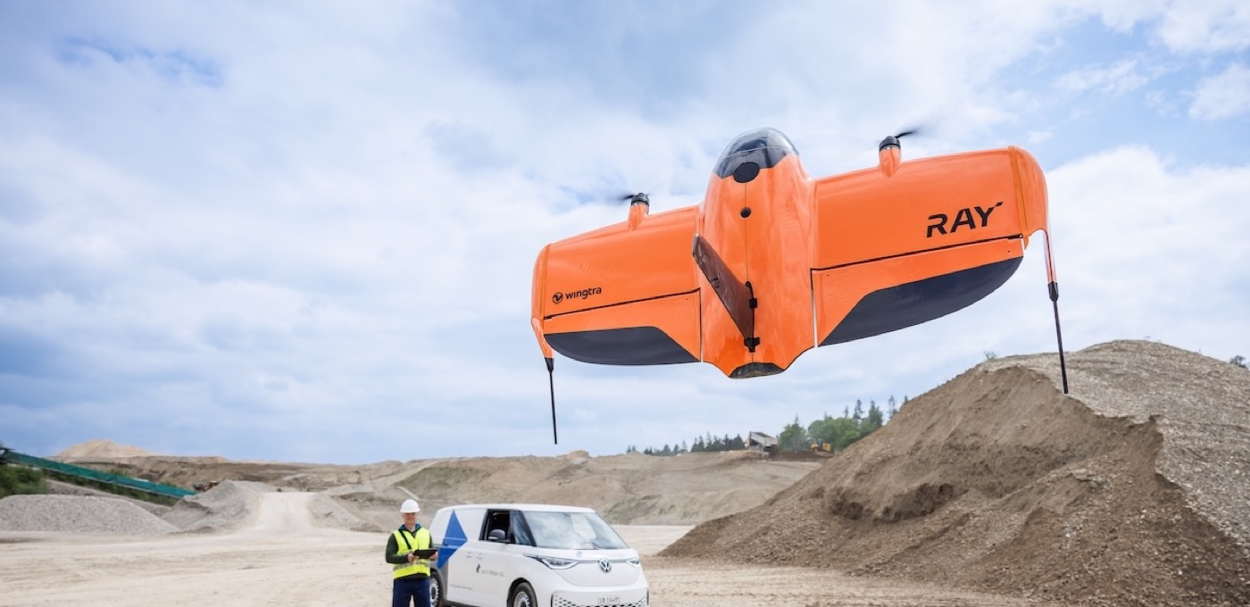 WingtraRAY aircraft flying near an operator at a quarry